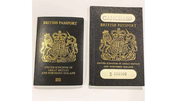 A handout picture released by the UK Home Office press office shows covers of the new blue passport (left) with the old style pre-burgundy United Kingdom passport.