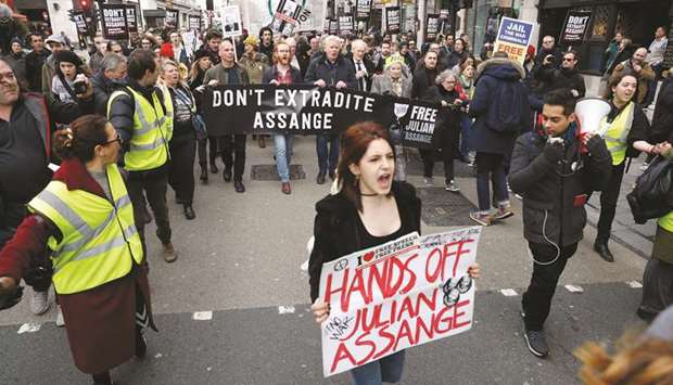 Demonstrators gather outside the Australian High Commission in London to protest against the extradition of Julian Assange.