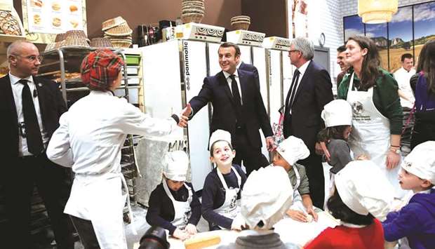 Macron at a cereal sector stand during his visit to the 57th International Agriculture Fair (Salon de lu2019Agriculture), at the Porte de Versailles exhibition centre in Paris.