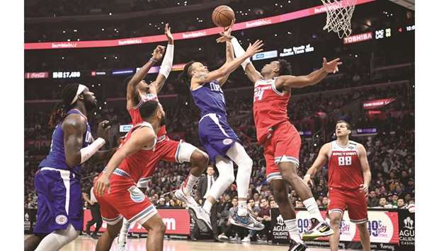 LA Clippers guard Amir Coffey (7) has his shot block by Sacramento Kings guard Buddy Hield (24) during the fourth quarter of their game on Saturday. PICTURE:  Robert Hanashiro-USA TODAY Sports