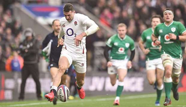 Englandu2019s wing Jonny May (left) makes a break during their Six Nations match against Ireland at the Twickenham, west London, yesterday. (AFP)