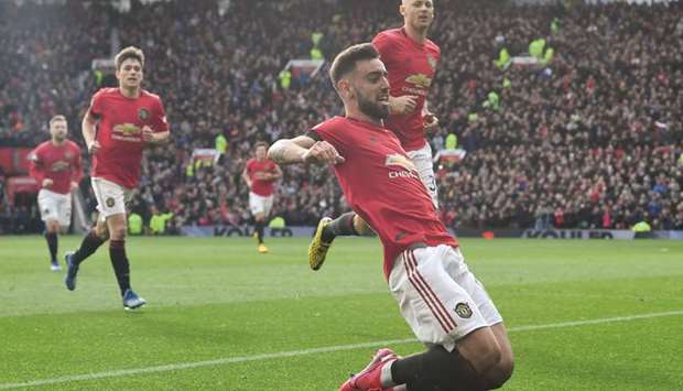Manchester Unitedu2019s Portuguese midfielder Bruno Fernandes (foreground) celebrates scoring the opening goal from the penalty spot during the English Premier League match against Watford at Old Trafford in Manchester. (AFP)