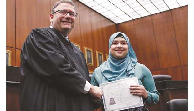 Lila Mubarak receives a certificate of naturalisation during a ceremony in Chicago.