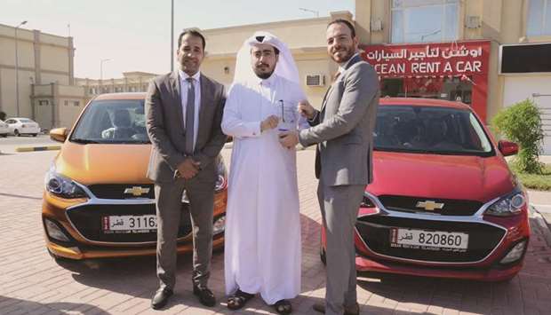 Jaidah Automotive and Ocean Rent a Car officials mark the occasion.