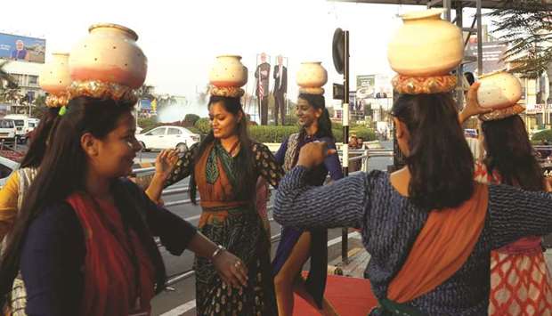 Girls perform a folk dance in front of cutouts of Prime Minister Narendra Modi and Donald Trump along a road, during a rehearsal ahead of the US presidentu2019s visit in Ahmedabad yesterday.