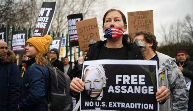 Supporters of WikiLeaks founder Julian Assange,hold placards calling for his freedom outside Woolwich Crown Court in southeast London