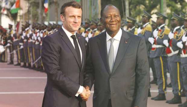 Franceu2019s President Emmanuel Macron is welcomed by Ivory Coast President Alassane Ouattara in Abidjan on December 22, 2019.