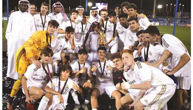 Real Madrid players celebrate with the trophy after winning the Al Kass International Cup at the Aspire Academy yesterday. PICTURE: Jayaram