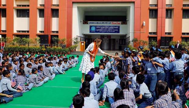 US first lady Melania Trump greets children at the Sarvodaya Co-Education Senior Secondary School in Moti Bagh, in New Delhi