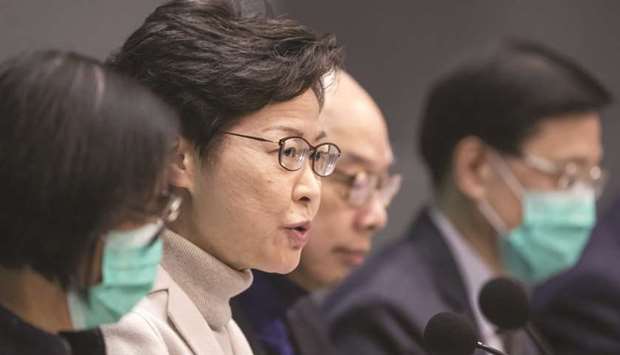 Carrie Lam, Hong Kongu2019s chief executive (second left), speaks during a news conference in Hong Kong. Lam earlier this month pledged an extra HK$30bn in funding, targeting those affected by the virus outbreak.