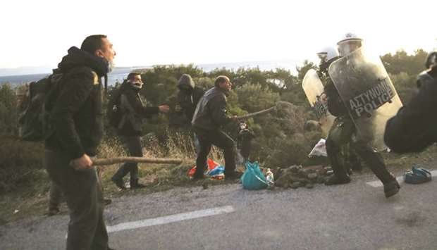 Locals scuffle with riot police at the area where the government plans to build a new closed migrant detention centre, in Karava on Lesbos island.