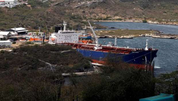 A crude oil tanker is docked at Isla Oil Refinery PDVSA terminal