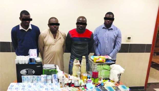 Arrested gang members and the items seized from their residence