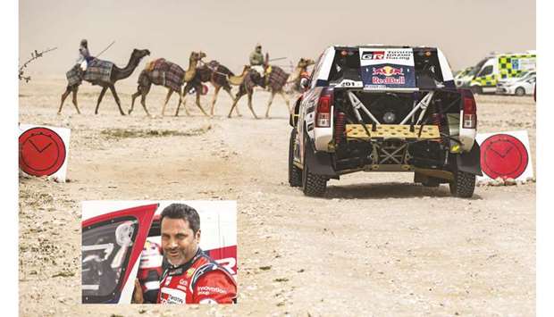 Nasser Saleh al-Attiyah (also inset) waits for the start of the penultimate stage of the Manateq Qatar Cross-Country Rally yesterday.