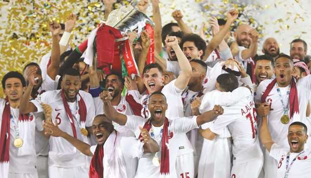 The victorious Qatar team celebrate with the Asian Cup trophy last year.