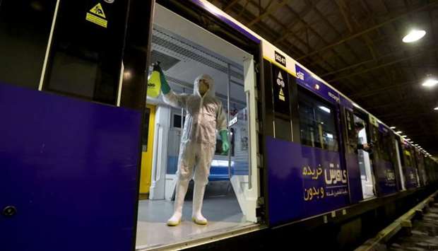 A Tehran Municipality worker cleans a metro train to avoid the spread of the COVID-19 illness