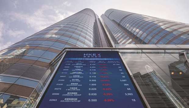 A screen displays stock figures outside the Exchange Square complex, which houses the Hong Kong Stock Exchange.