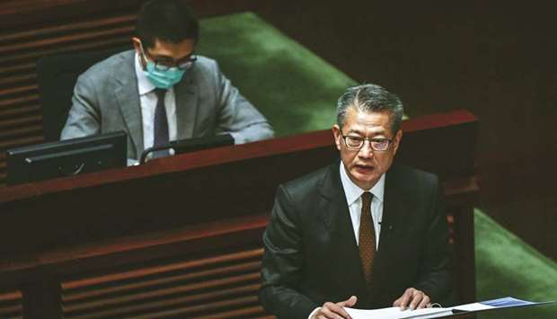 Hong Kong Financial Secretary Paul Chan (right) delivers the annual budget at the legislative council in Hong Kong yesterday.