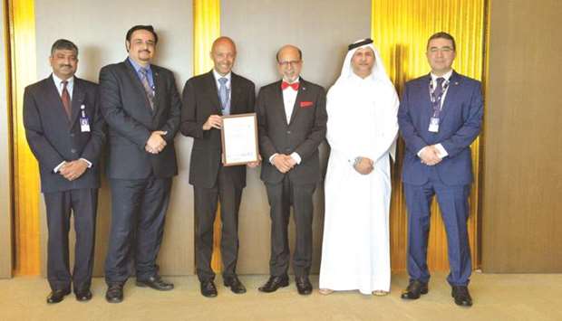 Doha Bank Group CEO Dr R Seetharaman with other dignitaries during the handing over of the recertified ISO 20000 certification.