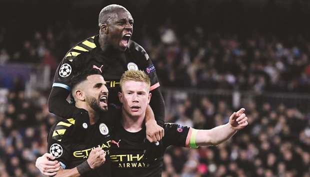 Manchester Cityu2019s Belgian midfielder Kevin De Bruyne (right) celebrates his goal with teammates during the UEFA Champions League round of 16 first-leg match against Real Madrid at the Santiago Bernabeu Stadium in Madrid. (AFP)