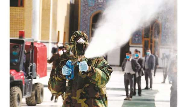 A member of the Iraqi civil defence sprays disinfectant around the Great Mosque of Kufa, 10km northeast of the shrine city of Najaf in central Iraq. Iraq yesterday announced the first confirmed case of coronavirus in Baghdad, taking nationwide infections to six and raising concerns about the capacity of the dilapidated health system to respond.