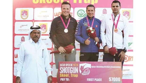 First-placed Erik Varga (second from right) of Slovakia, second-placed Matthew Coward-Holley (second from left) of Great Britain and David Kostelecky (right) of Czech Republic pose with vice-chairman of the organising committee Majid  Ahmad Majid al-Naimi on the podium of menu2019s trap event at the Qatar Open Shotgun Championship at the Losail Shooting Range yesterday.