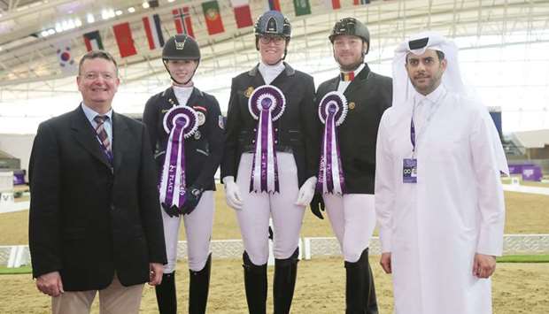 Asian and Qatar Equestrian Federation President and member of the Supreme Organising Committee of the Commercial Bank CHI Al Shaqab Presented by Longines Hamad Abdurahman al-Attiyah (right) poses with the the Para Dressage winners.