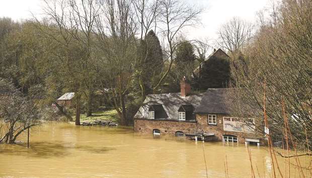 Flood waters lap against the partially submerged The Boat Inn in Jackfield, near Ironbridge, Shropshire, yesterday.