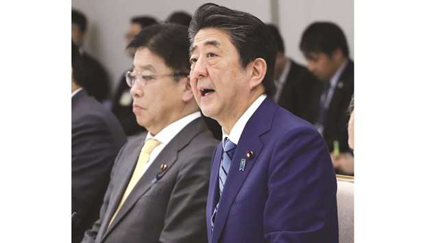 Japanu2019s Prime Minister Shinzo Abe (right) and Health Minister Katsunobu Kato attend a meeting at the new Covid-19 coronavirus infectious disease control headquarters at the prime ministeru2019s office in Tokyo yesterday.