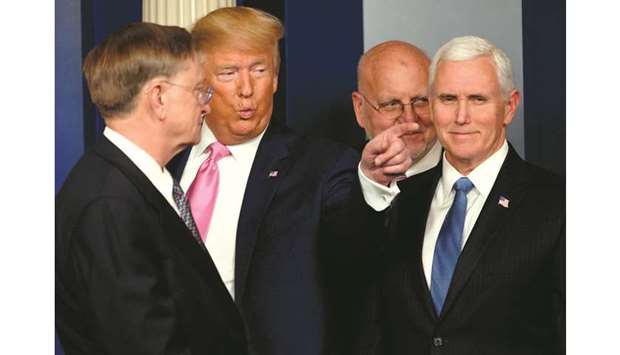 Trump gestures, flanked by Vice-President Pence, after speaking at a news conference on the Covid-19 outbreak at the White House.