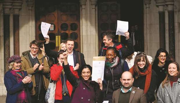 Campaigners against Heathrow expansion celebrate as they leave the Royal Courts of Justice in London yesterday after a decision by the Court of Appeal.