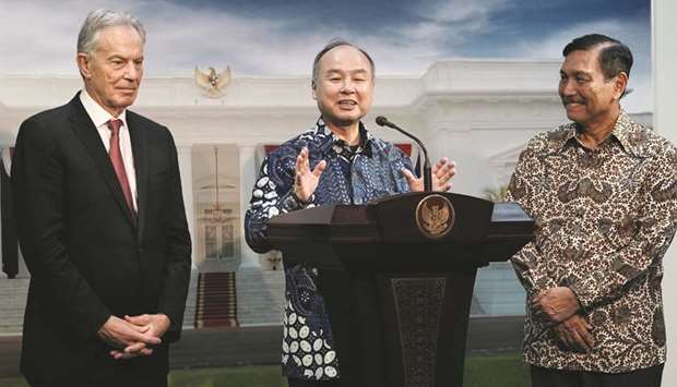 Masayoshi Son, chairman and chief executive officer of SoftBank Group (centre), speaks alongside Tony Blair, UKu2019s former prime minster (left), and Luhut Binsar Pandjaitan, Indonesiau2019s maritime affairs minister, during a news conference in Jakarta. Widodou2019s ambitious plan to build a new capital gathered momentum with Son and Blair holding discussions on the contours of the $34bn project.