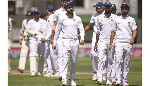 Indiau2019s captain Virat Kohli (centre) walks from the field with his teammates after the first Test against New Zealand at the Basin Reserve in Wellington on February 24, 2020. (AFP)