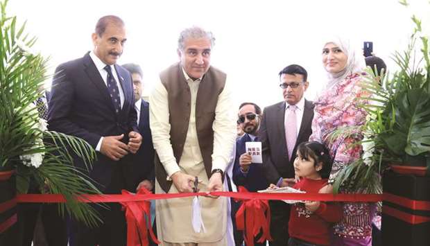 Makhdoom Shah Mehmood Qureshi, Pakistanu2019s Minister for Foreign Affairs, cutting a ribbon yesterday to formally inaugurate the new complex for the embassy of Pakistan in Qatar at Diplomatic Area Onaiza. Ambassador Syed Ahsan Raza Shah and other dignitaries look on. PICTURES: Jayan Orma