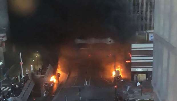 Vehicles and bins burning in a street aside the Gare de Lyon rail station in Paris yesterday