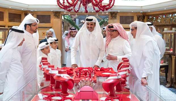 His Highness the Amir Sheikh Tamim bin Hamad Al-Thani visits a pavilion at Doha Jewellery and Watches Exhibition