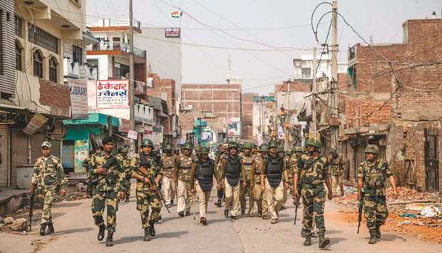 Security personnel patrol a street following sectarian riots at Shiv Vihar in New Delhi yesterday.