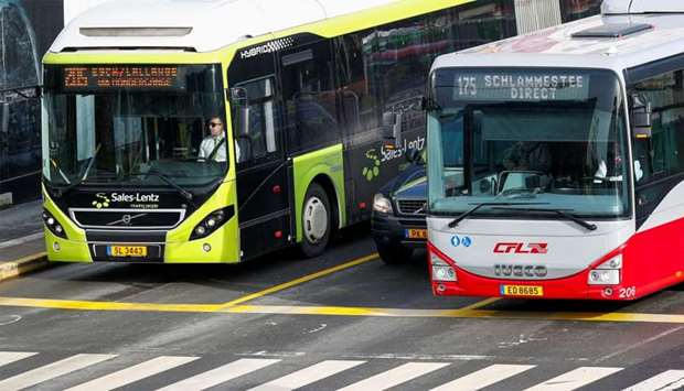 Buses and a car are seen in central Luxembourg, as it becomes the first country in the world to offer free public transport