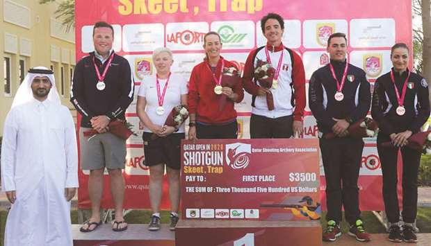 First-placed Spanish team of De Souza Ferreira-Fatima Galvez Marin, second-placed British team of Matthew Coward-Holley-Kirsty Hegarty and third-placed Italian team of Emanuele Buccolieri-Erica Sessa pose on the podium of mixed team trap event at the  Lusail Shooting Complex.