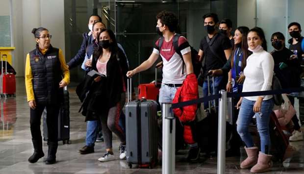 Mexican students wear protective masks upon their arrival at the Del Bajio International Airport, after the Guanajuato state government arranged the return from China for Mexican students due to the coronavirus outbreak, in Silao, Mexico