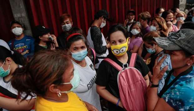A long queue is formed outside a medical supply store that sells face masks, a day after the Philippine government confirmed the first novel coronavirus case, in Manila, Philippines, January 31