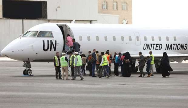 People board a United Nations plane which will carry them to Amman, Jordan in the first flight of a medical air bridge from Sanaa airport in Sanaa, Yemen