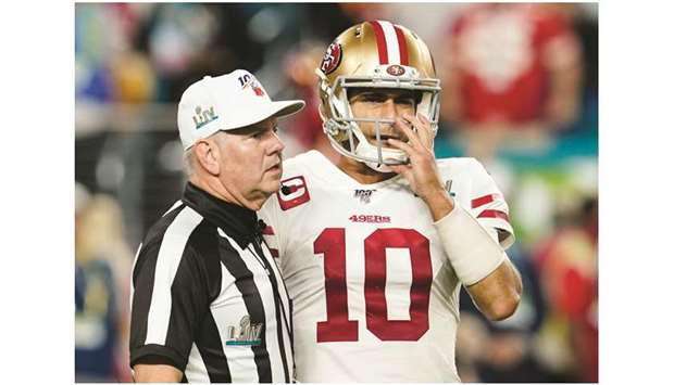 San Francisco 49ersu2019 Jimmy Garoppolo (right) talks with the referee during the Super Bowl game. (Reuters)