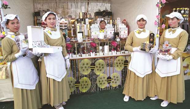 Staff welcoming visitors to a stall at the International Honey Exhibition, Souq Waqif. PICTURES: Jayaram