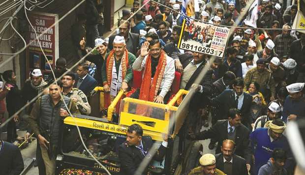 Delhi Chief Minister Arvind Kejriwal waves to supporters during a road show ahead of Delhi election, yesterday.