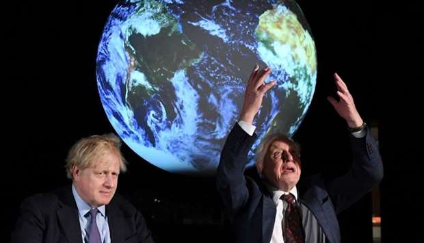 British Prime Minister Boris Johnson sits with David Attenborough during a conference about COP26 UN Climate Summit, in London