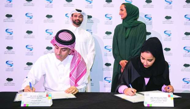 QF, SC officials sign the pact in developing Qatar 2022 visitor experience as HE Sheikha Hind bint Hamad al-Thani, vice chairperson and CEO of Qatar Foundation, and Hassan al-Thawadi, secretary general of the SC, look on.