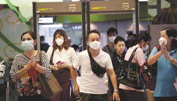 People wearing protective masks are seen in Bangkok yesterday.