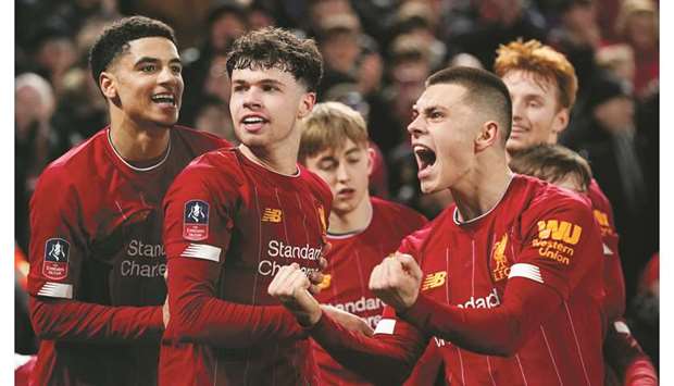 Liverpoolu2019s Neco Williams (right) celebrates with teammates after Shrewsbury Townu2019s Ro-Shaun Williams scored an own goal during the FA Cup fourth round match in Liverpool on Tuesday night. (Reuters)