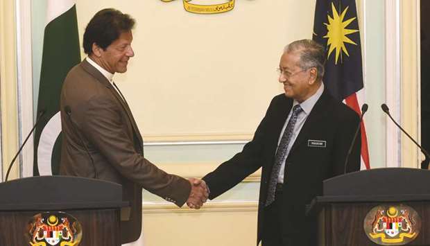 WARM AS EVER: Pakistani Prime Minister Imran Khan shakes hands with Malaysian Prime Minister Mahathir Mohamad in Putrajaya, south of Kuala Lumpur, on Tuesday. AFP
